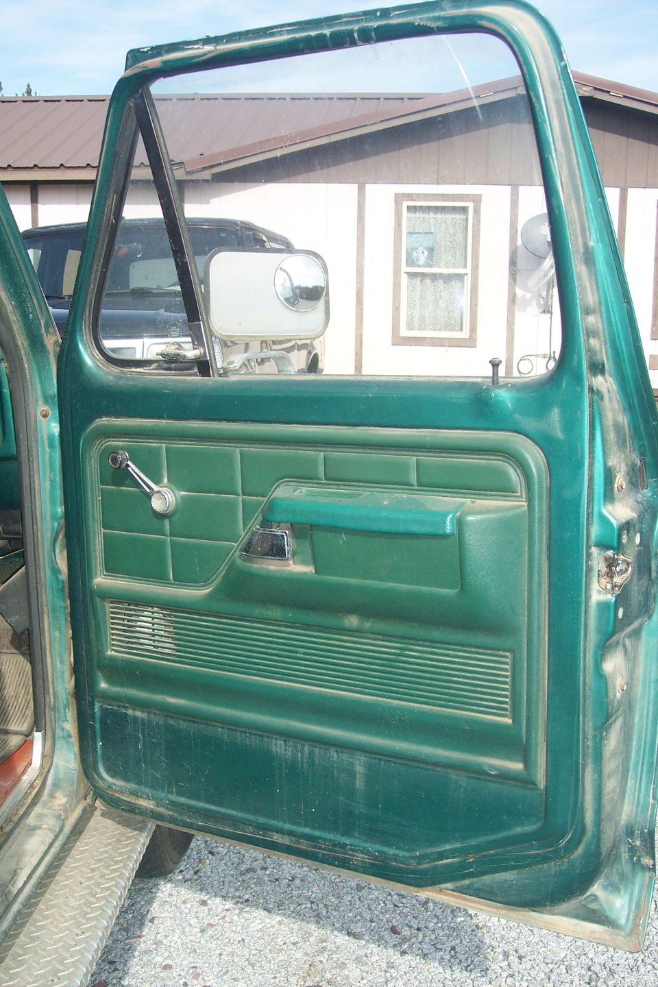 Green 1977 Ford F-150 interior door panel and window frame