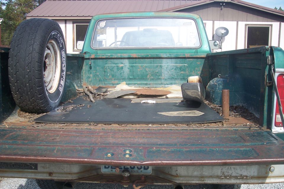 1977 Ford F-150 bed interior with spare tire mounted on left side