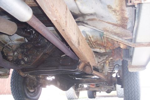 1977 Ford F-150 - Underside view of a 1977 Ford F-150, revealing its frame, exhaust system, and drivetrain components.