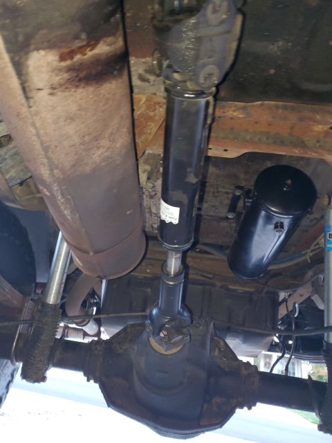 1996 Ford Bronco - The underside of a vehicle shows the driveshaft, differential, and an auxiliary air tank, suggesting modifications for off-road use or spec…