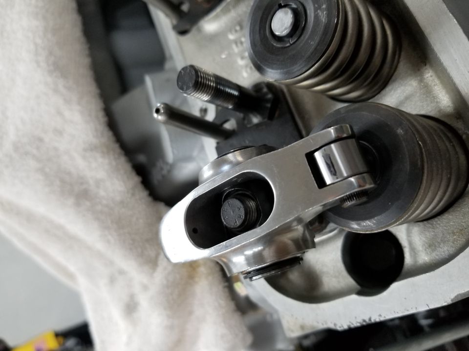 Close-up of engine valve train with rocker arm, valve spring, and pushrod