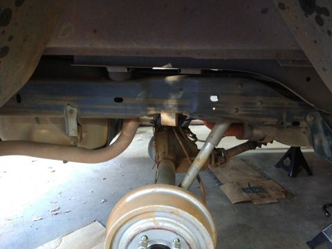 1996 Ford Bronco - The underside of a 1996 Ford Bronco shows the rear axle, suspension components, and exhaust system, with the vehicle supported by jack stan…