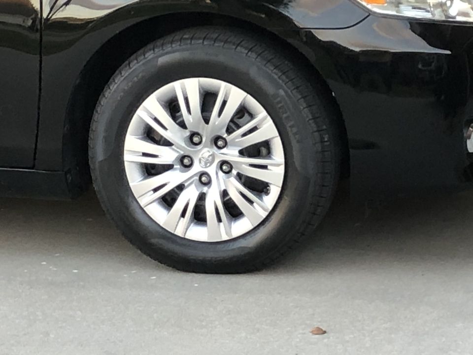Black sedan front driver's side wheel and fender