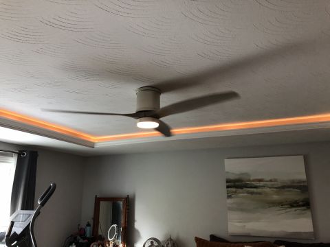 1995 Mercury Grand Marquis - A ceiling fan with orange LED lighting is visible in a room with textured ceilings and a large abstract painting on the wall.