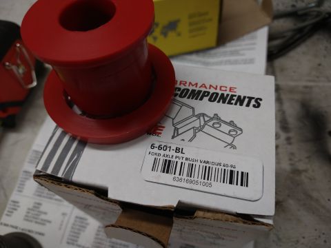 1996 Ford Bronco - A red polyurethane bushing sits on top of a white box labeled "PERFORMANCE COMPONENTS" and "FORD AXLE PVT BUSH VARIOUS 80-95".