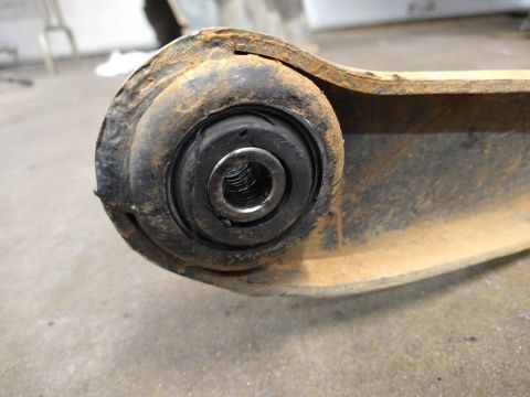 1996 Ford Bronco - Close-up of a worn suspension bushing on a rusty metal arm, with 'SUPERMOTORS.NET' visible at the bottom right.