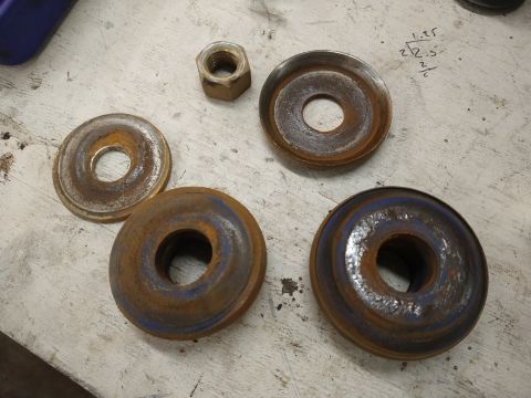 1996 Ford Bronco - Several used brake rotors and nuts are laid out on a surface.