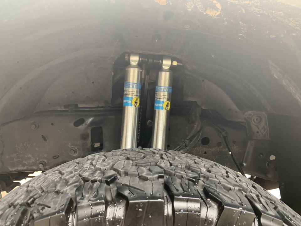 Rear suspension of a vehicle with Bilstein shock absorbers and tire.