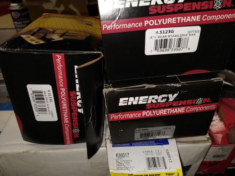 1996 Ford Bronco - Two boxes of Energy Suspension polyurethane components are shown, one labeled "4.3133G AXLE PIVOT BUSHINGS" and the other "4.5123G .875 REA…