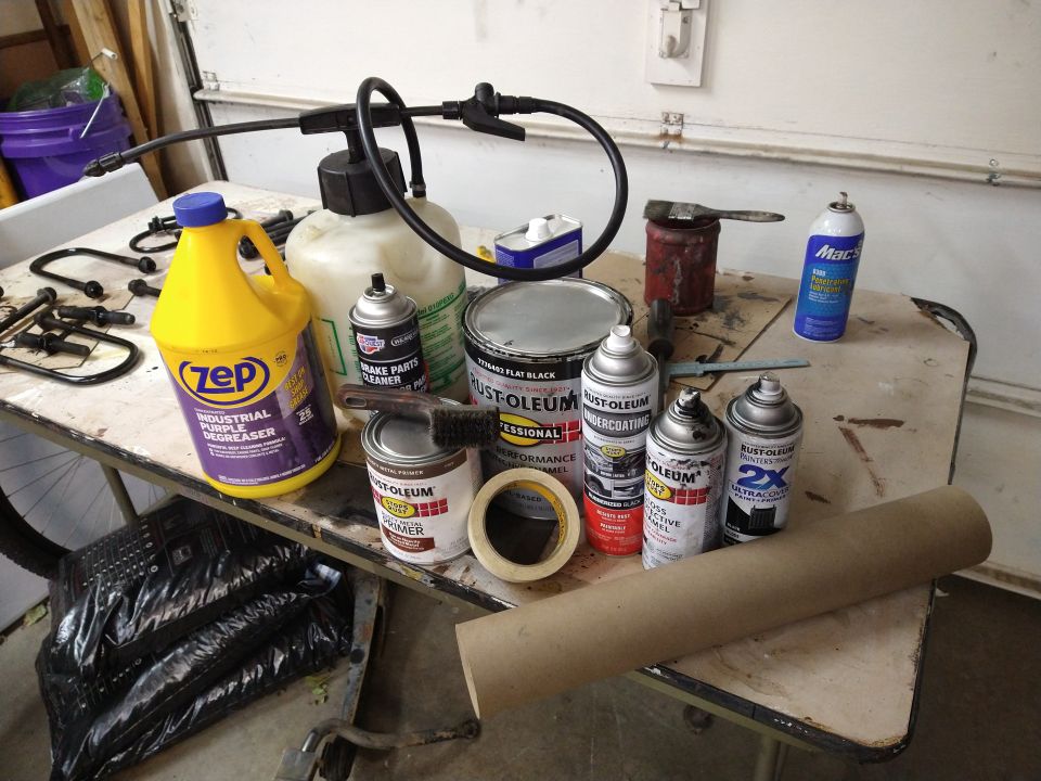 Automotive maintenance and painting supplies on a workbench.