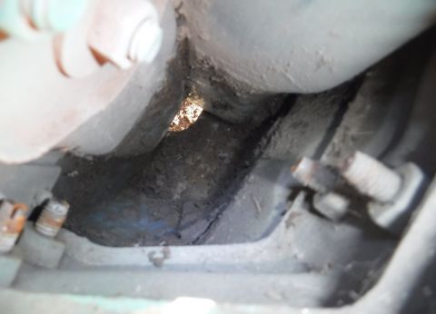 1992 Ford Bronco - Dirt mostly cleared out below the tail light. You know it's a lot when that size hole isn't big enough to let it fall through.