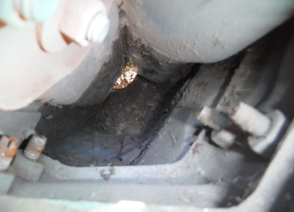 Dirt mostly cleared out below the tail light.  You know it's a lot when that size hole isn't big enough to let it fall through.