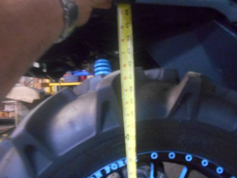 1992 Ford Bronco - A yellow measuring tape is held vertically against the side of a large, knobby tire on a vehicle. The tape shows measurements up to 46 inch…