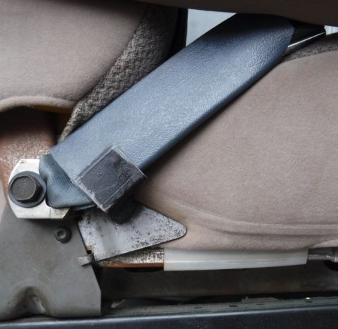 1992 Ford Bronco - Seat belt pivot stop installed. No more reaching below the arm rest to find the receiver!
