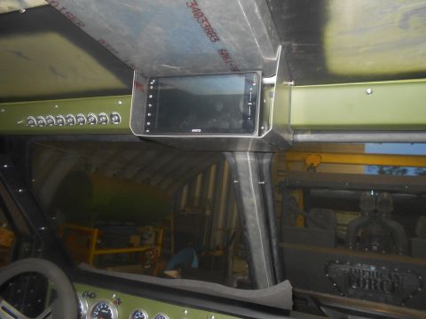 1992 Ford Bronco - Interior view of a custom vehicle, showing a mounted touchscreen display above a row of toggle switches and a steering wheel. A metal dashb…
