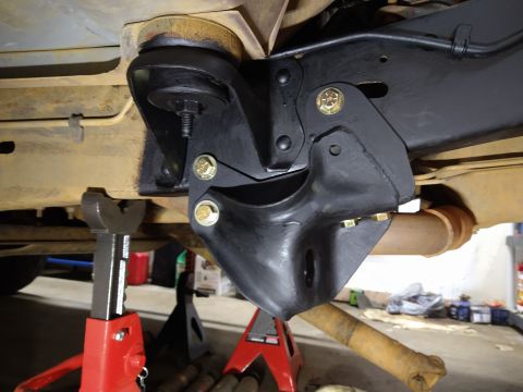 1996 Ford Bronco - Close-up view of aftermarket suspension components installed on a vehicle frame.