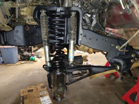 1996 Ford Bronco - Close-up view of front suspension parts during a vehicle repair or modification project.