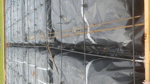 1995 Ford Bronco - Rebar and plastic sheeting laid out for concrete pour at a construction site.