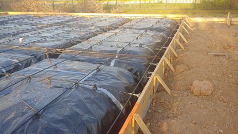 1995 Ford Bronco - Foundation construction in progress, showing rebar and plastic sheeting laid out for a concrete pour.