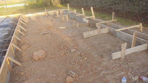 1995 Ford Bronco - Construction site with wooden forms and rebar ready for concrete pouring.