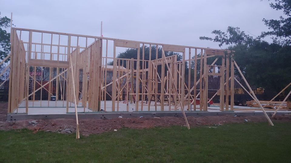 Building under construction with wooden framing visible