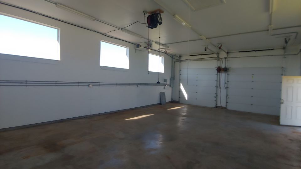 Garage interior with large bay doors and windows