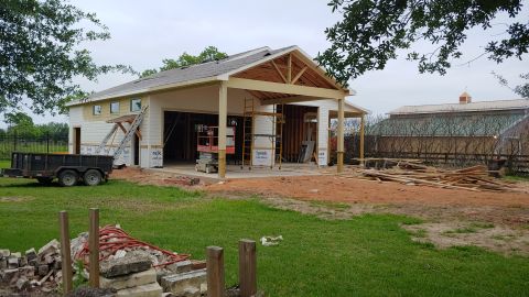1995 Ford Bronco - A garage is under construction with building materials scattered around the site.