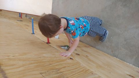 1995 Ford Bronco - Young child explores a construction area with visible plumbing pipes.