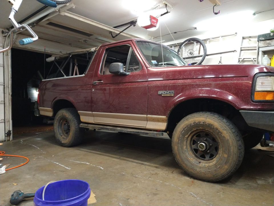 Maroon 1996 Ford Bronco with a lifted suspension