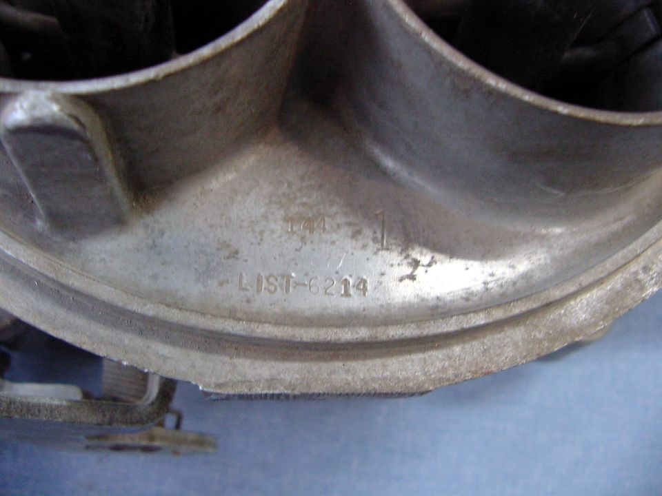 Close-up of a metal part with stamped text LIST-6214