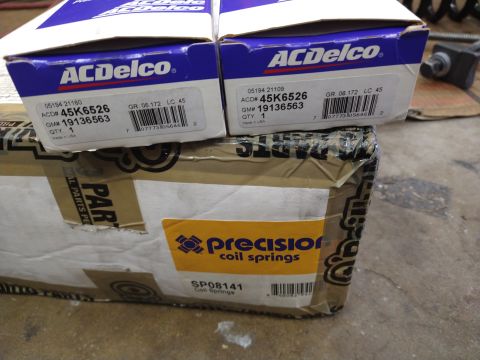 1996 Ford Bronco - Boxes of automotive parts, including ACDelco and Precision coil springs, are stacked and ready for use.