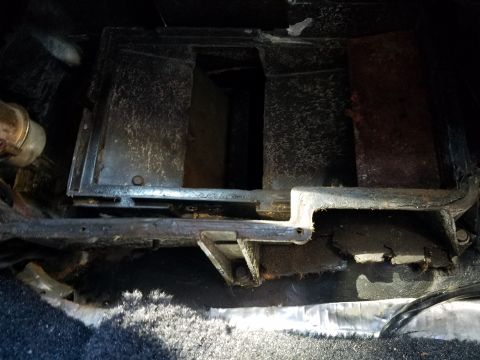 1976 Ford Ranchero - This photo shows the interior heater box assembly of a vehicle, with visible metal components and carpeting.