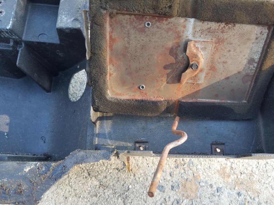 Heater box assembly with rusty metal plate and bent metal rod