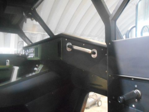 1992 Ford Bronco - Interior view of a vehicle's dashboard and door panel, showing a grab handle and various controls.