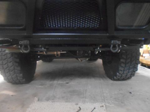1992 Ford Bronco - Front view of a black SUV, showing its heavy-duty bumper, tow hooks, and aggressive off-road tires.