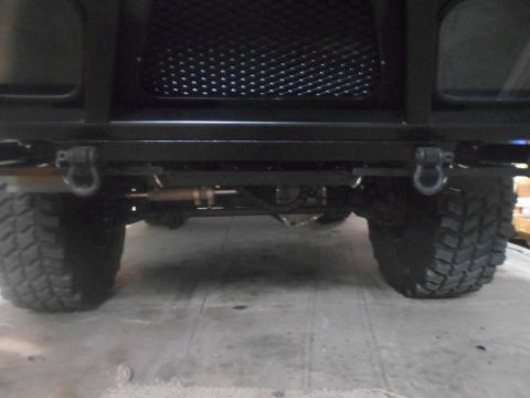 1992 Ford Bronco - Close-up of the front bumper and tires of a vehicle.