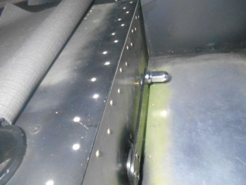 1992 Ford Bronco - Close-up of a metal panel with visible rivets and a protruding bolt, with the Supermotors.net logo in the corner.
