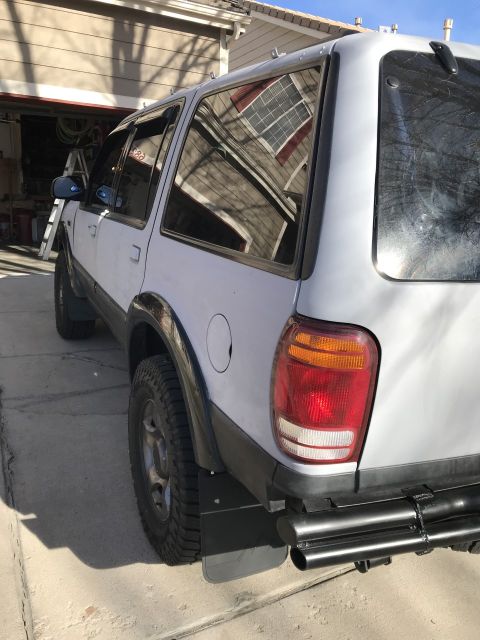 2000 Ford Explorer - The rear section of a 2000 Ford Explorer is shown parked outside a garage.