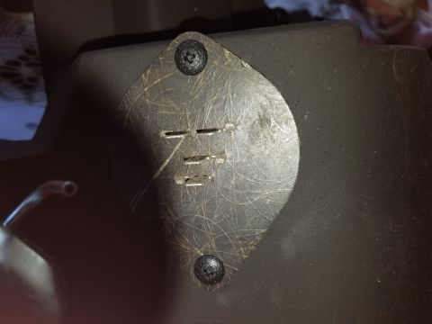 1976 Ford Ranchero - This image shows a close-up of a metal plate with slots and screws, likely a component of a vehicle's heater control system.