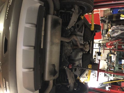 2019 Ford Everest - Underside view of a vehicle being serviced on a lift, with various mechanical parts visible.