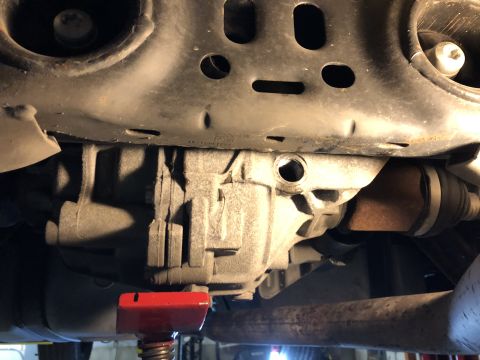 2019 Ford Everest - Close-up view of the rear axle and drivetrain components of a vehicle, likely undergoing maintenance.
