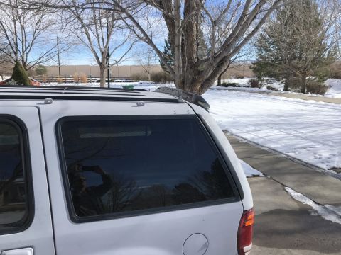 2000 Ford Explorer - Rear view of a silver SUV parked on a snowy driveway.
