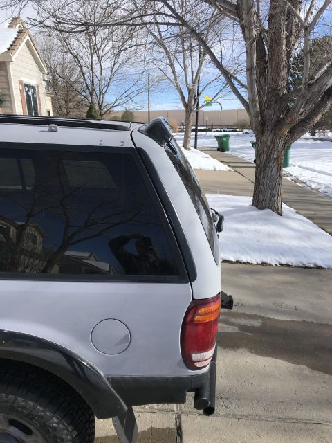 2000 Ford Explorer - Rear view of a white SUV, identified as a 2000 Ford Explorer.