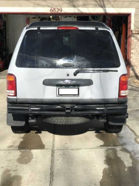 2000 Ford Explorer - The rear of a Ford Explorer is shown, parked in front of a garage door with the number 6829 visible.
