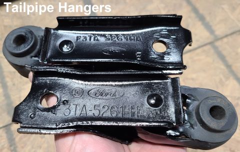 Two Ford tailpipe hangers with part numbers F3TA 5261 HA stamped on them