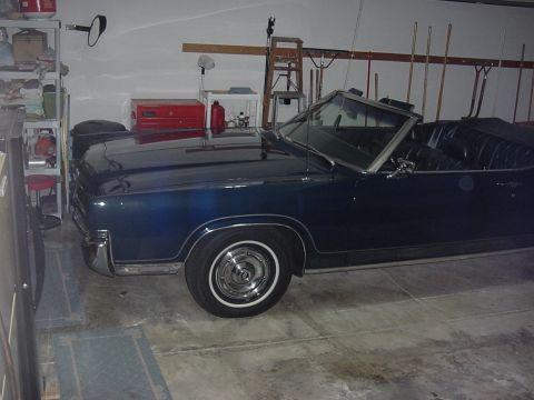 1969 Mercury Marquis - Marquis is parked in garage with top down for a day or two. There is a work bench in front of the car.