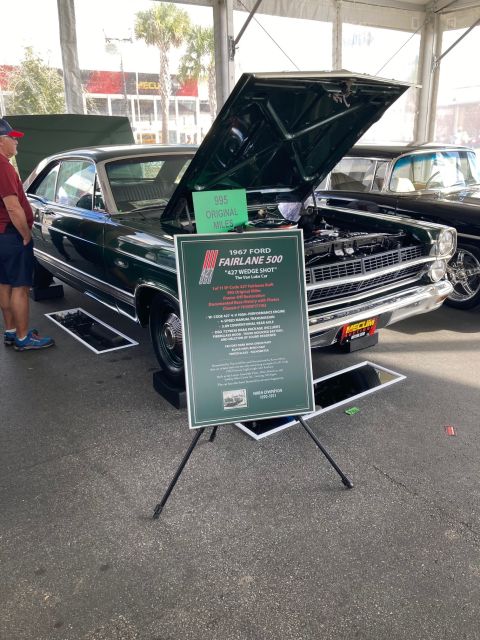 1968 Mercury Cougar - The hood of a car is open, revealing the windshield and interior details. Another vehicle is partially visible in the background.