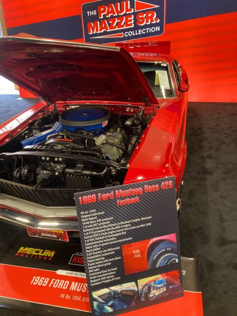 1968 Mercury Cougar - A sign details the specifications of a 1969 Ford Mustang Boss 429 Fastback displayed at an auction.