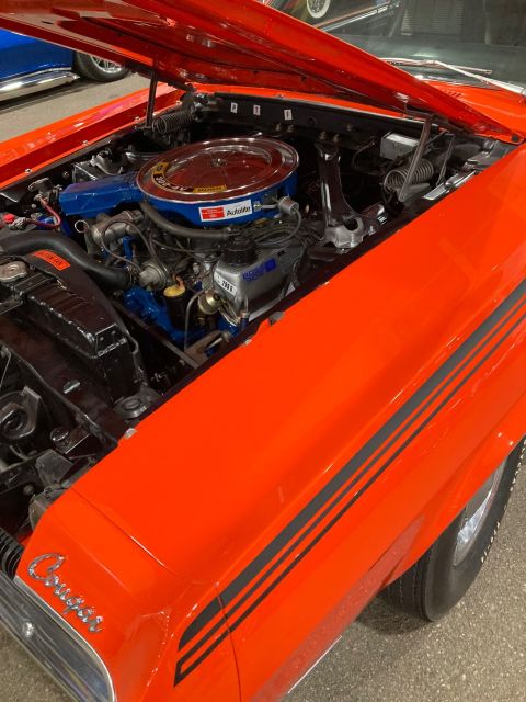 1968 Mercury Cougar - The engine bay of a 1968 Mercury Cougar shows its V8 engine and distinctive fender stripes.