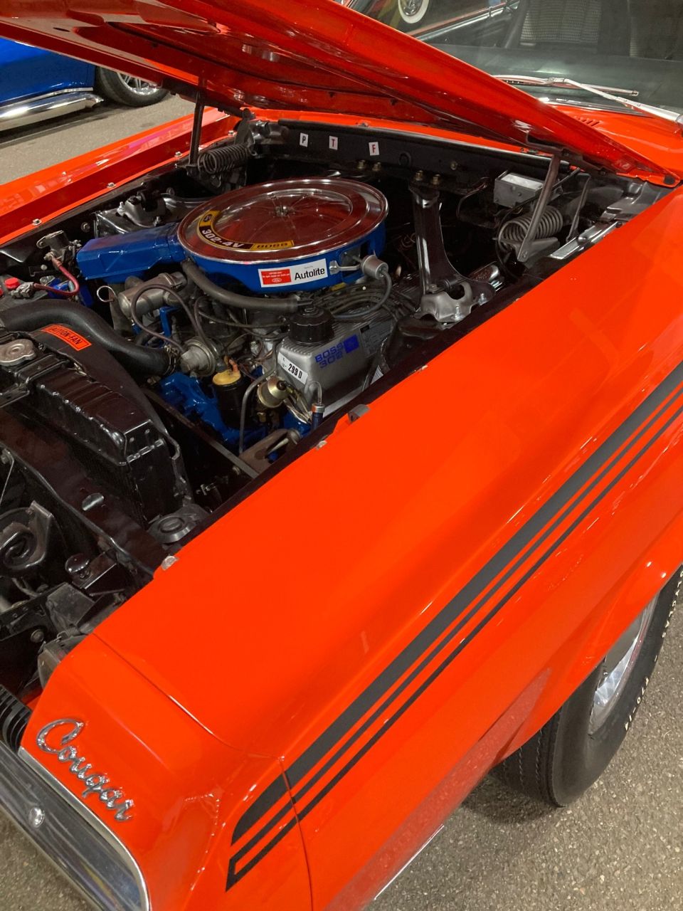 1968 Mercury Cougar engine bay with V8 engine, Autolite air cleaner, and black stripes on fender